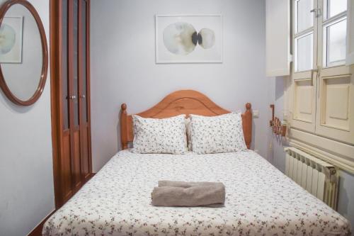 a bedroom with a bed with a hat on it at Plaza Consti, Heart of the old town in San Sebastián