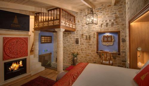 a bedroom with a fireplace and a bed in a room at KAMARES Historic Boutique Hotel & Spa in Ioannina