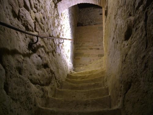 an alley with stairs in a stone building at Fattoria Pogni in Marcialla