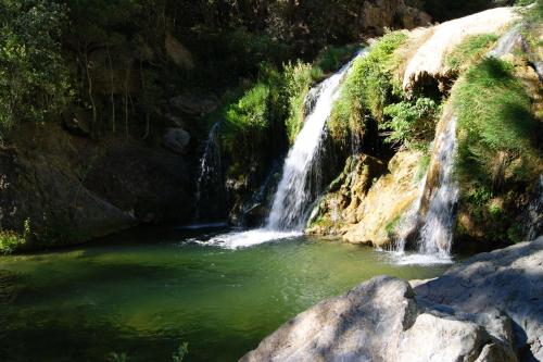 a waterfall in the middle of a river at Chambre et Gite Le Roc sur l'Orbieu in Saint-Pierre-des-Champs
