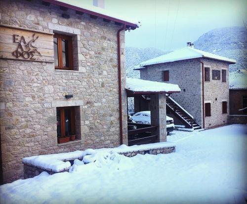 a building with snow on the ground in front of it at Elafos Spa Hotel in Elliniko