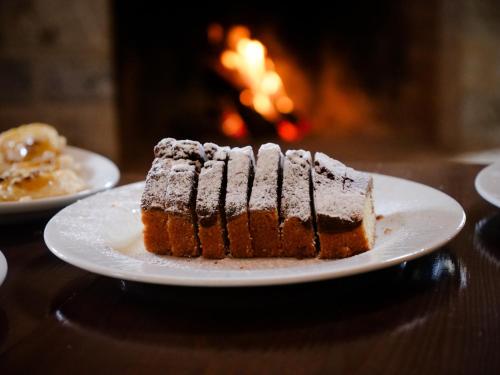 a piece of cake on a plate on a table at Elafos Spa Hotel in Elliniko