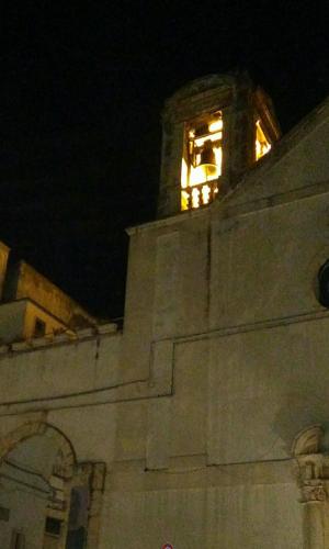 a clock tower on top of a building at night at ARCOBELLO Suite Rooms in Castellana Grotte