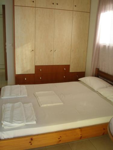 a large bed with white sheets and towels on it at Eolia beachfront studios in Plakias