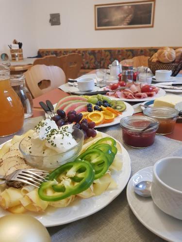 a table with plates of food on top at Urlaub am Bauernhof Feldbauer in Landl