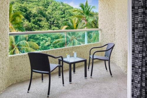 two chairs and a table on a balcony at Dreams Huatulco Resort & Spa in Santa Cruz Huatulco