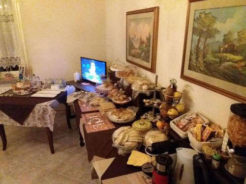 a room with a table filled with lots of food at Locanda 130 in Fonni