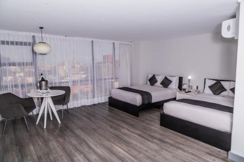 a hotel room with two beds and a table at Hotel El Ejecutivo by Reforma Avenue in Mexico City