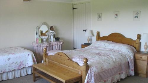 Łóżko lub łóżka w pokoju w obiekcie Pigeonwood House