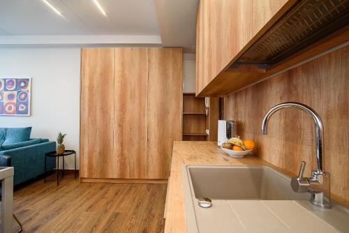 eine Küche mit einem Waschbecken und einem Sofa in einem Zimmer in der Unterkunft Apartment with amazing view! in Vilnius