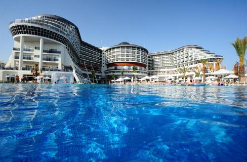 a pool of water in front of a building at Seaden Sea Planet Resort & Spa All Inclusive in Kızılot
