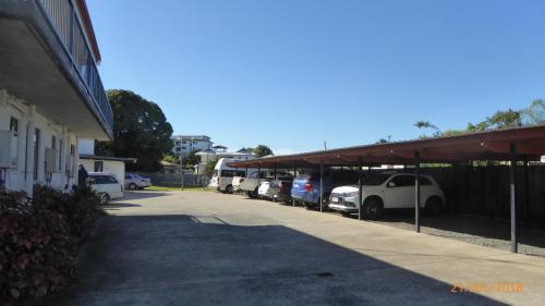 a row of cars parked in a parking lot at Tower Court Motel - adults only haven in Hervey Bay