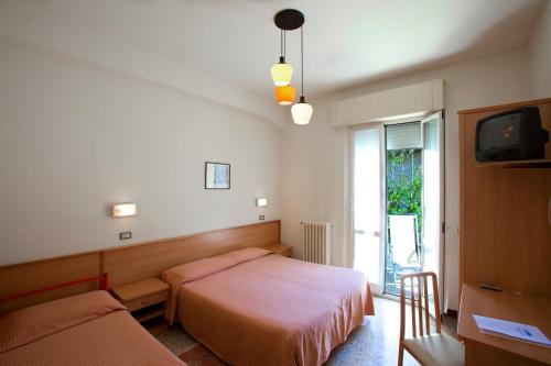 Postel nebo postele na pokoji v ubytování Albergo Moretti