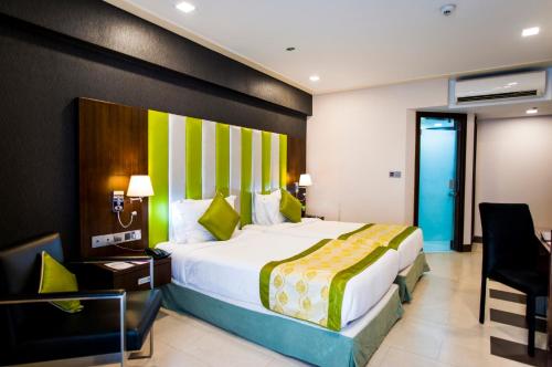A bed or beds in a room at Platinum Grand