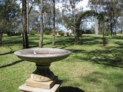 
a green and white fountain sitting in the middle of a grassy field at Hill Top Country Guest House in Lovedale
