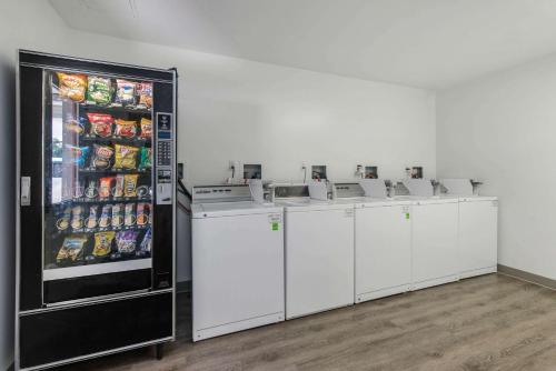 a row of washers and dryers in front of a refrigerator at Birch Hill Suites - Lakeland in Lakeland
