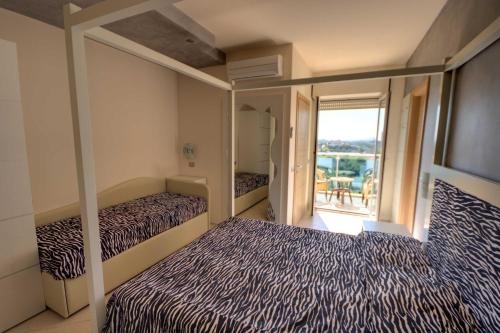 a bedroom with two beds and a balcony at Hotel Sydney in San Benedetto del Tronto