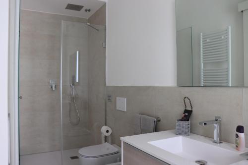 a bathroom with a shower and a toilet and a sink at Villa Emma in Montegranaro