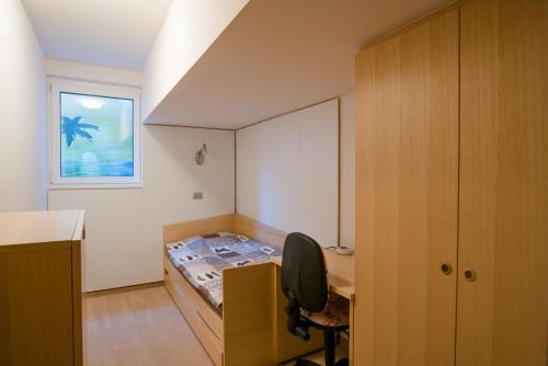 a bedroom with a bed and a desk and a window at Luxury apartment with a nice view in Kranjska Gora in Kranjska Gora