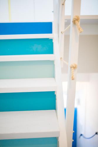 a ladder in a bunk bed with blue and white at Zagma Un Passo Dal Mare in Canneto