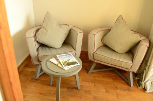 two chairs and a table with two pillows on them at Seehotel Luitpold in Tegernsee