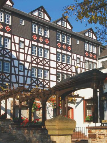 an old building with a bridge in front of it at Hotel Felsenkeller in Rüdesheim am Rhein