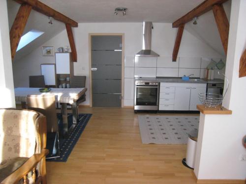a kitchen with a table and a dining room at Landhaus-Stockinger in Büchlberg