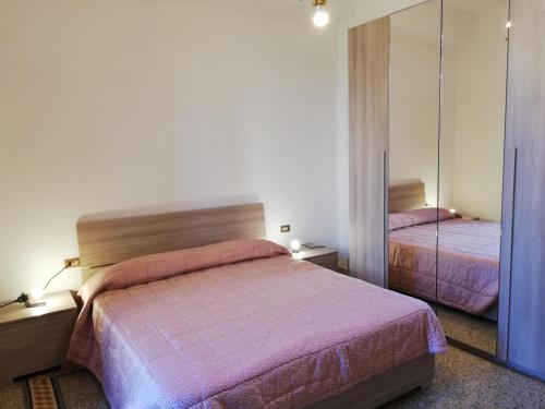 a bedroom with two beds and a mirror at Prato Barone a Firenze in Florence
