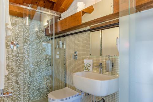 a bathroom with a sink and a toilet at Le Maestranze Deluxe Rooms in Sciacca