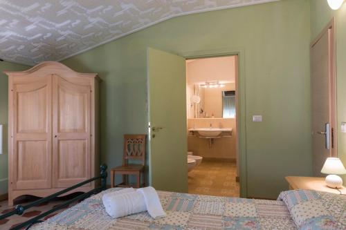 a bedroom with a bed and a bathroom with a sink at BB La Bella Addormentata e il Principe Calaf in Lucca