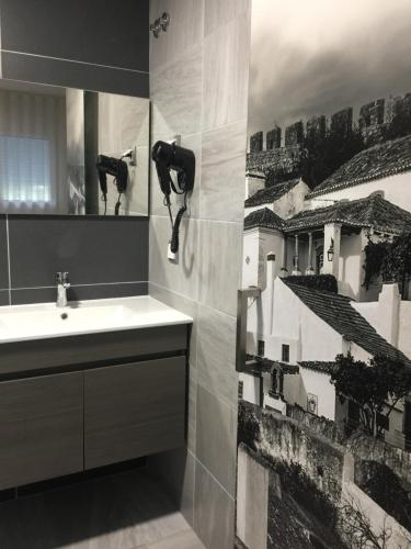 a bathroom with a sink and a mirror at PinoyHouse Fatima in Fátima