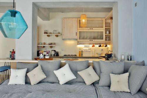 a living room with a blue couch with white pillows at Beach front Villa Melani in Mytilini