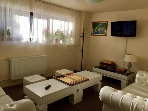 a living room with a couch and a table at Pensiunea Orizont in Poiana Brasov