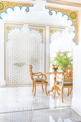 a room with two chairs and a table and a window at Taj Fateh Prakash Palace Udaipur in Udaipur