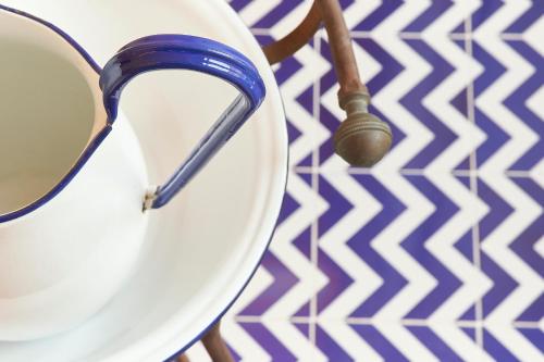 a white plate with a spoon on a table at Palazzo Gentilcore in Castellabate