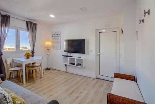 a living room with a couch and a table and a tv at Casa de Gaia in Vila Nova de Gaia