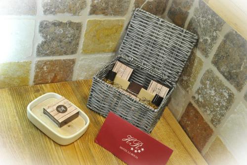 a wicker basket sitting on a table with a box at Hotel La Rouja in Champoluc