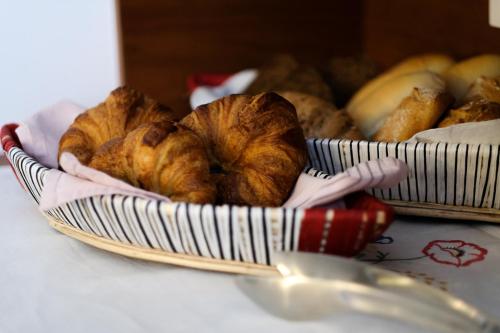 a basket filled with croissants and bread on a table at Casa Limon in Sanlúcar de Barrameda