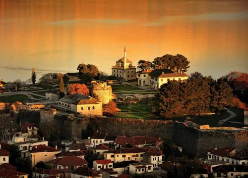 a painting of a town with a church on a hill at KAMARES Historic Boutique Hotel & Spa in Ioannina