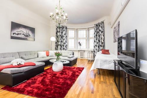 a living room with a couch and a red rug at Go Happy Home Apartments in Helsinki