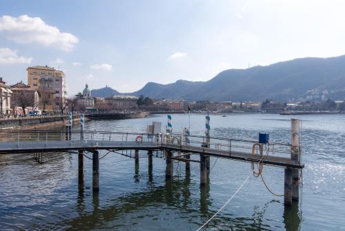 a dock in the middle of a body of water at Ca Mia - The House Of Travelers in Como