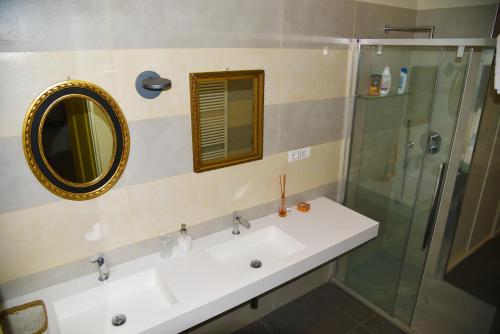 a bathroom with a sink and a glass shower at L'Amande in Genoa