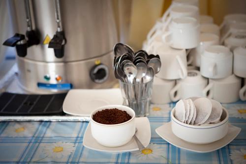 a counter top with two cups of coffee and a blender at Citrus Tree Gardens in Kérynia