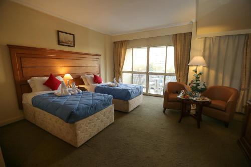A bed or beds in a room at Horizon Shahrazad Hotel
