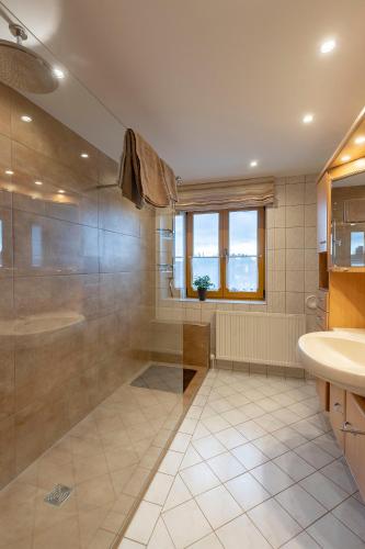 a bathroom with a shower and a tub and a sink at Ferienwohnung Lex in Bad Griesbach