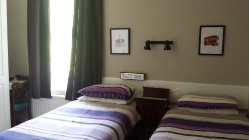 A bed or beds in a room at Brook Hotel 