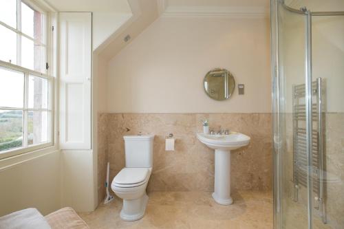 a bathroom with a toilet and a sink at Bowden House B&B in Melrose