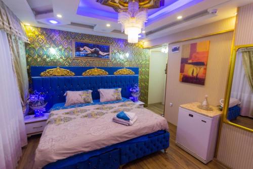 a bedroom with a blue bed in a room at MARKO PASA KONAGİ in Kuşadası