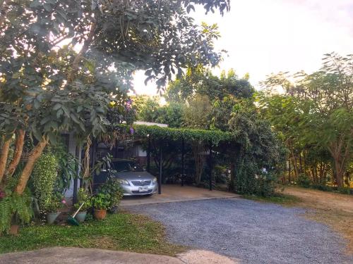 a car parked in the driveway of a house at Better Weather Homestay in Pak Chong