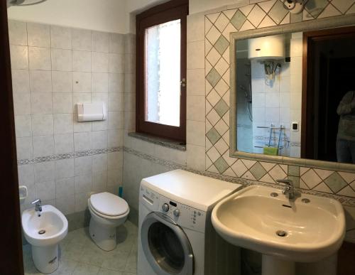 a bathroom with a washing machine and a sink at Appartamento Centrale in Olbia